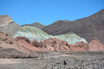 Scenic view of mountains against clear blue sky