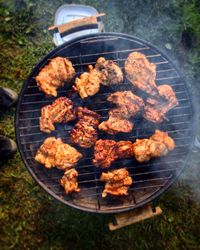 High angle view of meat on barbecue grill