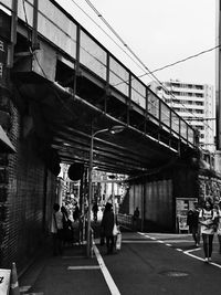 People walking on bridge in city