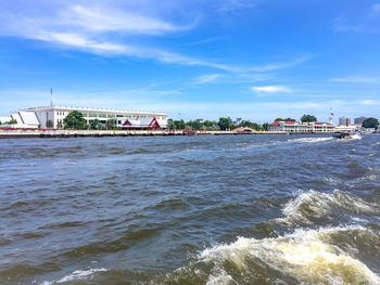 Scenic view of sea against sky in city