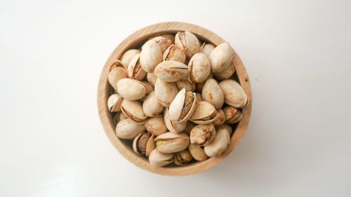 Directly above shot of cookies in bowl against white background