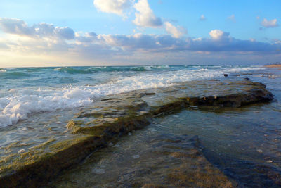 Scenic view of sea against cloudy sky