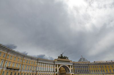 Low angle view of building against cloudy sky