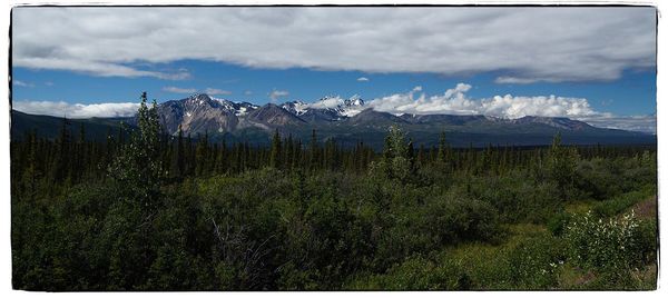 Scenic view of mountains against cloudy sky