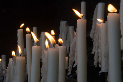 Close-up of candles burning in temple