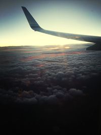 Cropped image of airplane flying over landscape