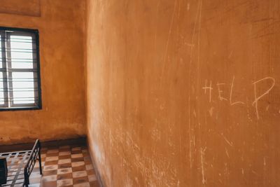 Empty chairs and table against wall at home