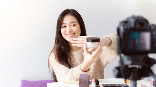 Portrait of a young woman drinking coffee