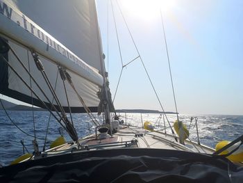 Sailboat sailing on sea against sky