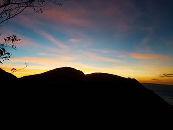 Scenic view of silhouette mountains against sky during sunset