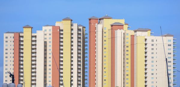 Low angle view of buildings against blue sky