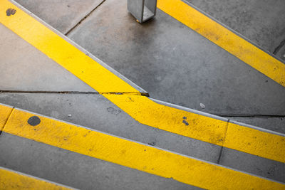 High angle view of yellow arrow symbol on road