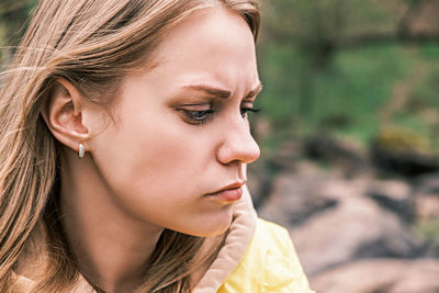 Side view portrait of a young serious upset woman clenching her teeth with a tense jaw. person
