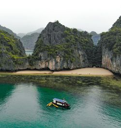 Scenic view of sea and mountains against sky