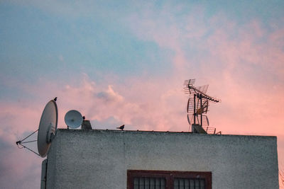 Low angle view of building against sky during sunset