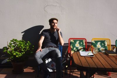 Rear view of man sitting on bench