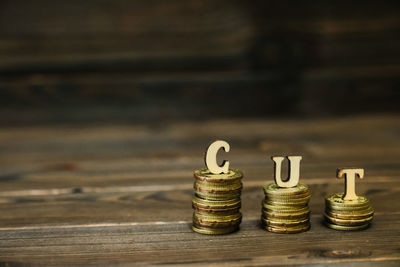 Close-up of coins with cut text on table