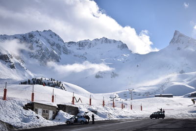 Scenic view of snow covered mountains against sky