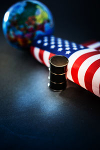 High angle view of miniature barrel with american flag and globe on table