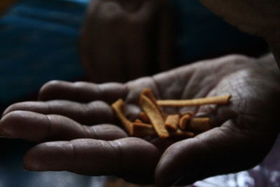 Close-up of hand holding cigarette