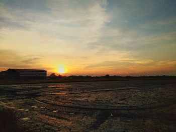 Scenic view of field against sky during sunset