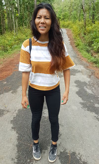 Portrait of smiling young woman standing outdoors