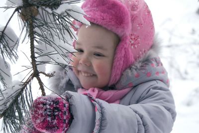 Close-up of woman with pink umbrella in winter