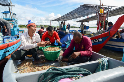 People sitting at market stall