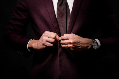 Midsection of man wearing suit