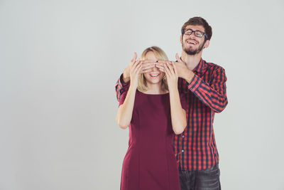 Portrait of young couple against white background