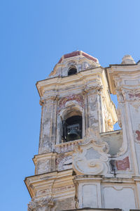 Low angle view of ornate building against clear blue sky