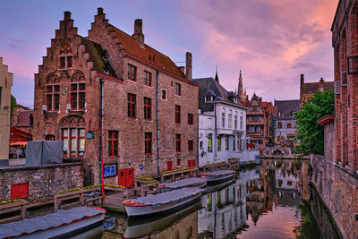 Canal passing through buildings in city