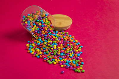 Colorful chocolate candy's, sugar coated chocolate gems candy on colorful background.