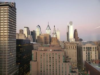 Modern buildings in city against clear sky