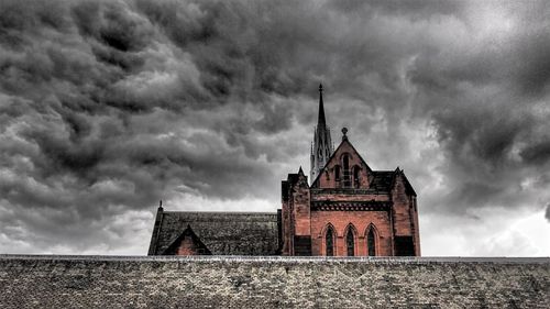 Low angle view of church against cloudy sky