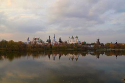 Panoramic view of lake by buildings against sky