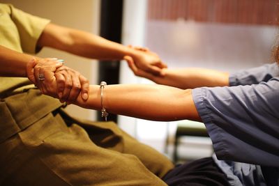 Midsection of woman giving massage to customer