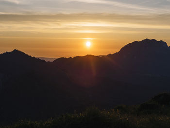 Scenic view of silhouette mountains against sky during sunset