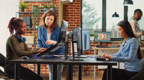 Young woman using laptop at cafe