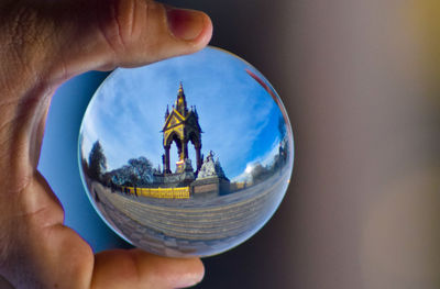 Midsection of person holding crystal ball