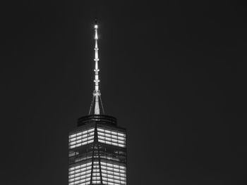 Low angle view of illuminated building against sky at night