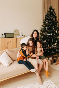 A large family celebrates christmas holidays in winter at home. mom with teenage children 