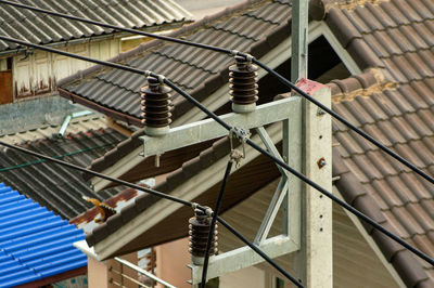 Low angle view of rope hanging on building