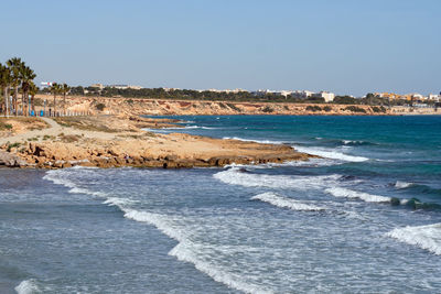 Scenic view of beach against clear sky