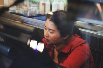 Serious woman sitting in restaurant