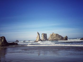 Panoramic view of sea against clear blue sky