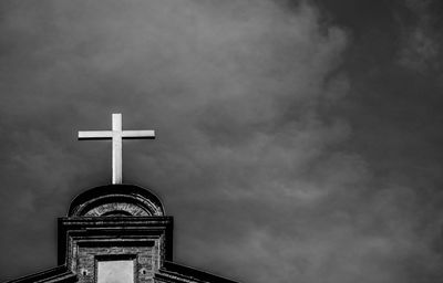 Low angle view of cross against sky