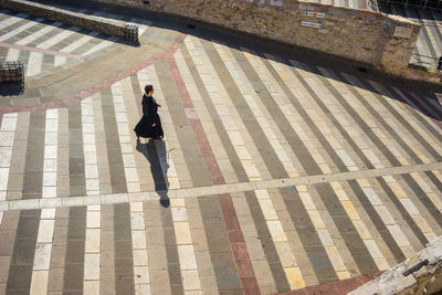 High angle view of woman walking on footpath