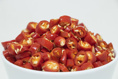Close-up of chopped vegetables in bowl against white background