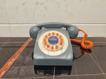 High angle view of old telephone on table